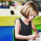 a child sorting objects by size, enhancing cognitive and motor development